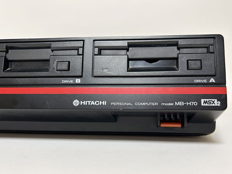 正面を見ると、左にシルバーの電源スイッチがあるほか、その上部に左からカートリッジスロット、FDD_B、FDD_Aと並んでいました。右下の奥まった部分には、赤色のリセットスイッチがあります。