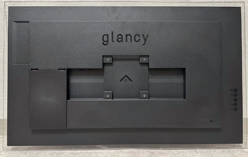 背面。10cm角のVESAマウント用のネジ穴はあるが、いわゆるスタンドは付属しない。その代わり壁掛け用機器がついてくる。右側には操作系ボタンがあるが、非常に使いづらい