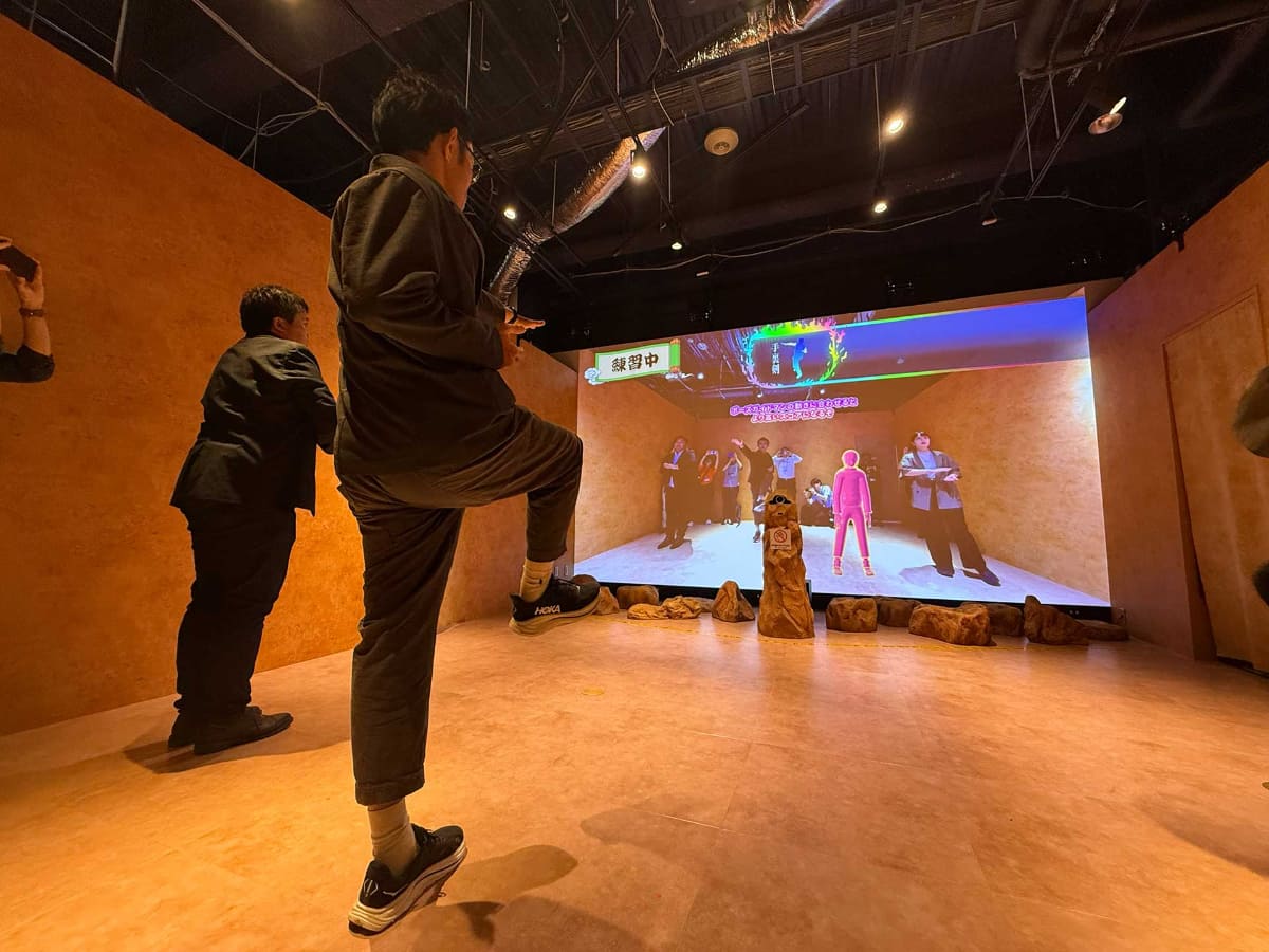 スタッフによるデモプレイの様子。軽いスクワットのようなポーズ、地面にしゃがみ込むポーズがあるので、思いのほかしっかり体を動かすことになる