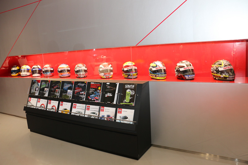 ショールームの壁面側には、これまでのレース活動で手にしてきたトロフィーやレーサーが着用したレーシングスーツなどの記念品を展示している