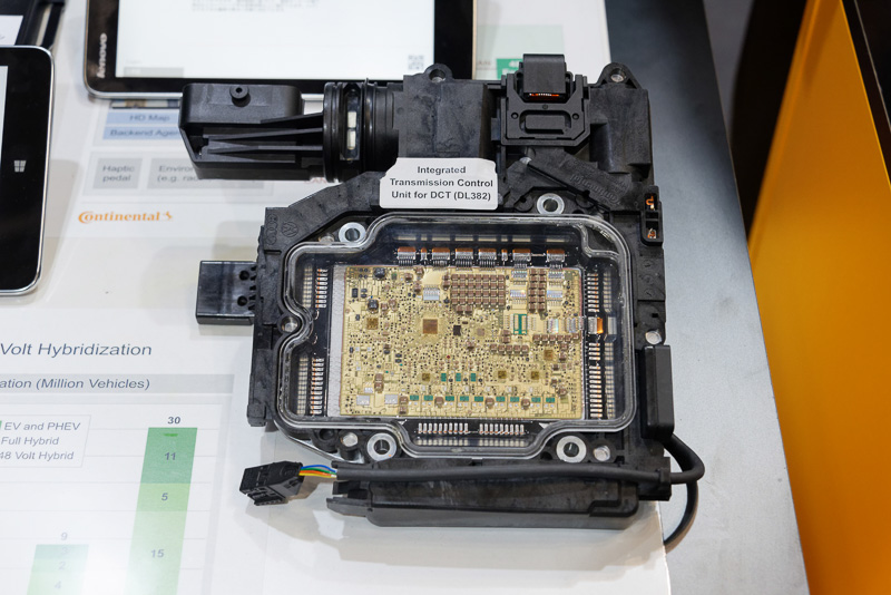 トランスミッションに内蔵する「機電一体型」のトランスミッションコントローラー。高温のオイルに浸かった状態になることから、それに耐えられるようエポキシベースの素材を用いた基板を開発。ケーブルも可能な限り使わずに小型化できるようワイヤーボンディングを多用して実装している