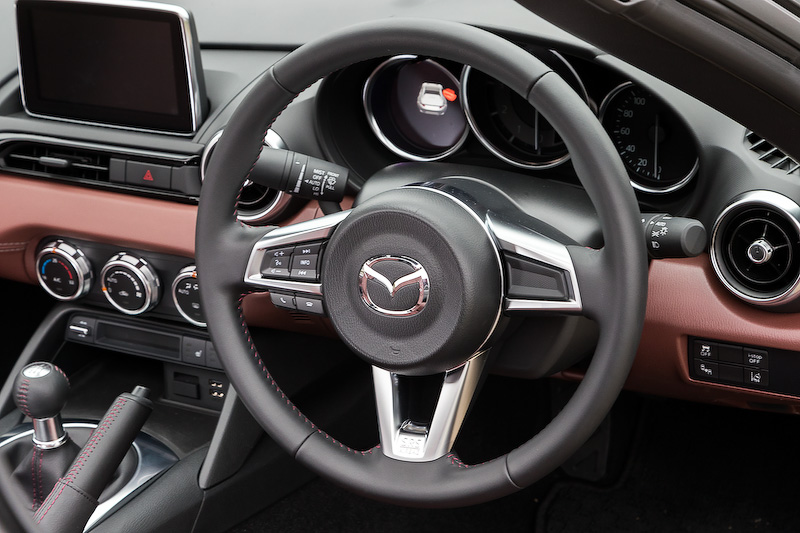 インテリアではBピラーや後方から巻き込んでくる風を効果的に抑えるため、リアルーフのトップ部形状を最適化するとともに、ソフトトップよりも大型のエアロボードを装備。またクローズ時の静粛性を高めるため、フロントルーフとミドルルーフの内側に吸音性能を持つ3層構造のヘッドライナーを採用し、ロードノイズや風切音を低減させている