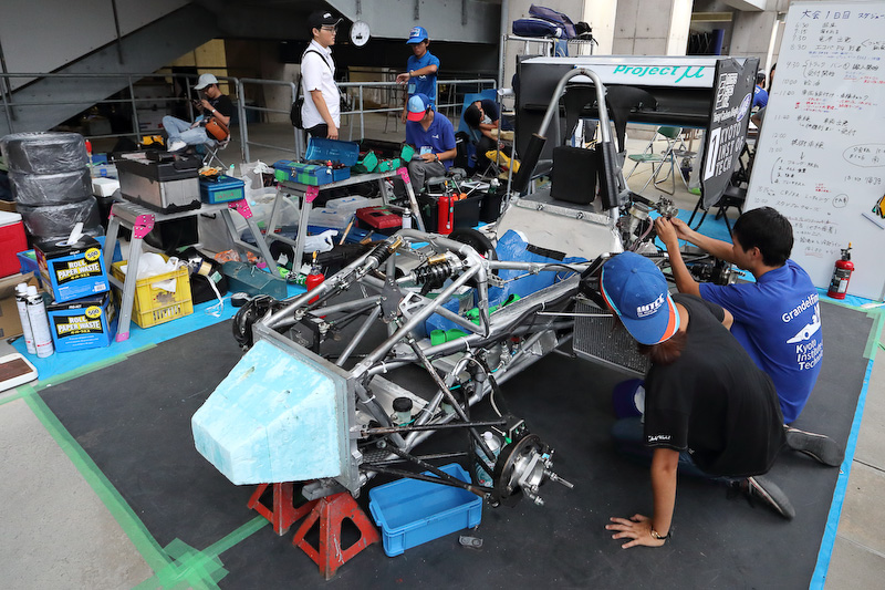 エコパスタジアムの2Fに割り当てられたピットで、車検を前に着々とマシンの整備を進める学生たち