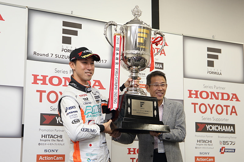 株式会社日本レースプロモーション 代表取締役社長 倉下明氏からチャンピオントロフィーを手渡される