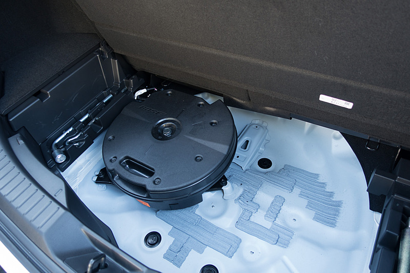 ラゲッジルーム下部のスペアタイヤボックスにある130mmRichBassウーファーは、このように配置。左にオフセットさせていることで、ユーティリティスペースを作り出している。指向性の弱い音域のため、この配置が気になることはない