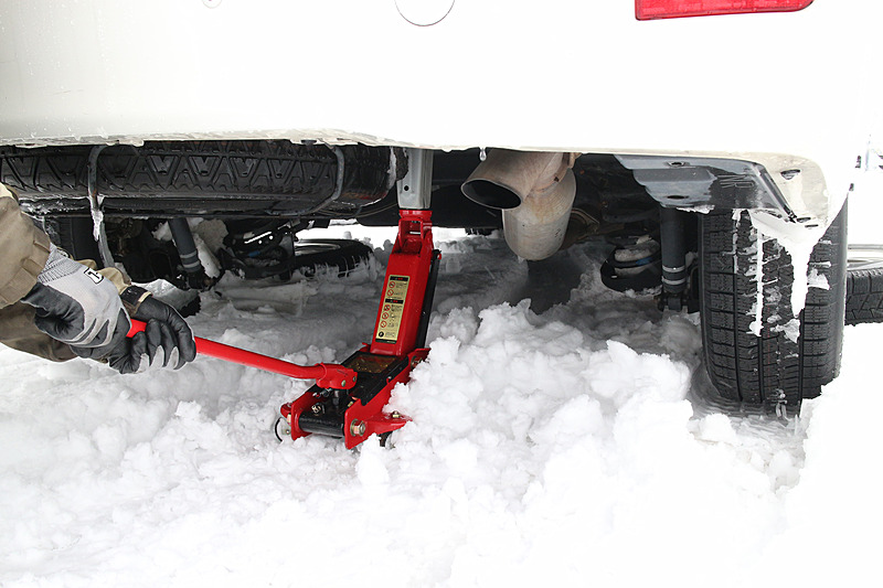 氷点下屋外での作業時間をできるだけ短縮するため、フロアジャッキは必須アイテム。雪の上で作業する際は、沈み込みや転倒に十分注意が必要だ（※土地所有者の許可を得て作業）