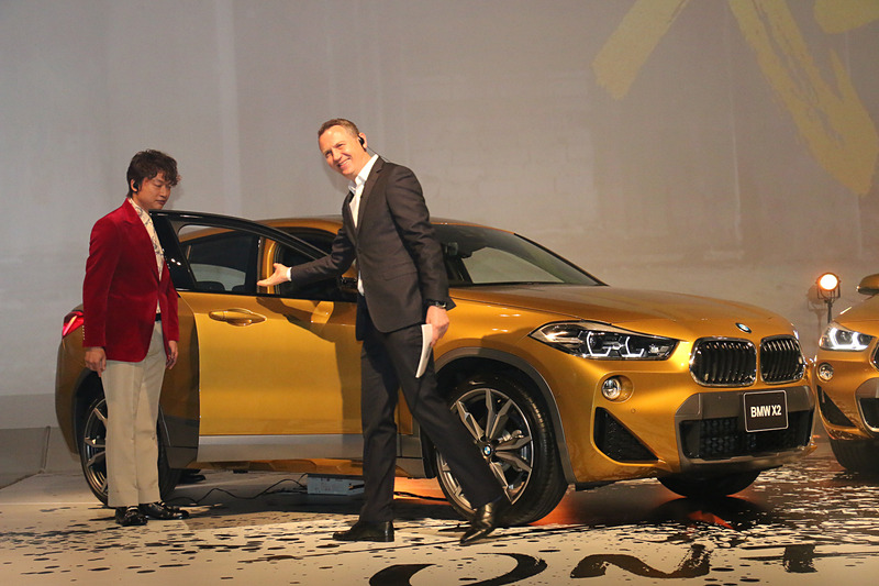 お披露目されたX2の外観を眺めた後、クロンシュナーブル氏に誘われてX2の運転席に座ってみる香取さん