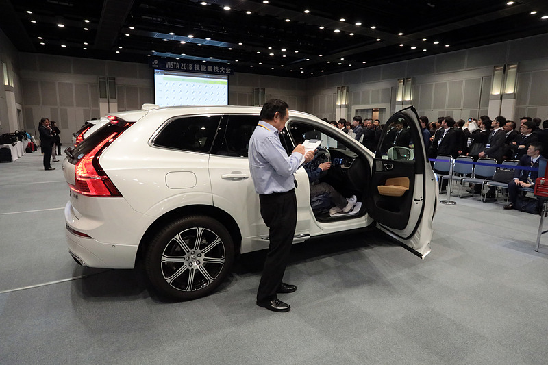 技術試験会場の様子。6台の「XC60 T8」（PHVモデル）が用意される。すべて同じ故障の設定。テクニシャン1名が対応し、制限時間55分の間に設定された設問に回答する。ただし、制限時間内に直しきることが目的ではなく、クルマの知識、診断スキル、機器の使い方、レポート内容などボルボの設定する手順をこなしているかを主に評価する