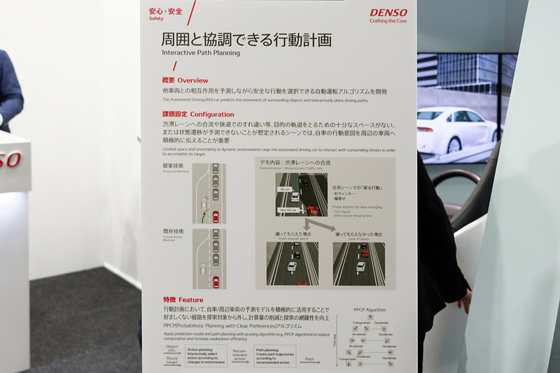 来場者が運転するのは赤いクルマ。自動運転車は白。衝突リスクに応じて進行方向の候補が矢印表示される。意地悪して自動運転車が合流させないようにすると、うまく後ろに並ぶ