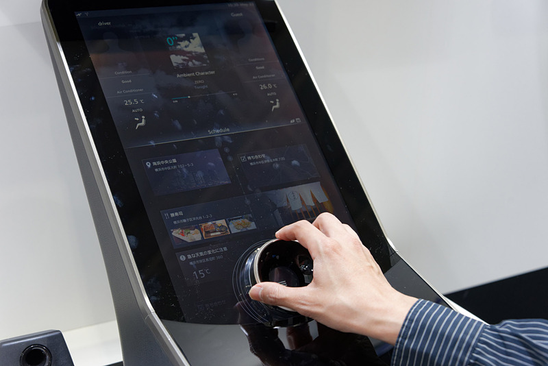 ダイヤルで操作するセンターコンソールのサンプル。左右へ動かすことで情報の詳細度を切り替え、回転操作で項目を選んでいく新発想の操作性