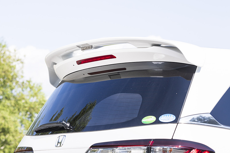 純正のテールゲートスポイラーに固定する「ウイングスポイラー」（未塗装5万6160円、カラード仕上げ6万4800円）は、センター部分に「無限メタルエンブレム」が付属する