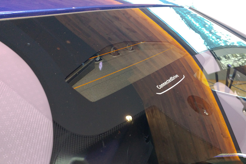 フロントガラス上部に装着される「トリプル・カメラ」。それぞれで短距離（広角）、中距離、長距離を担う。なお、ナンバー下にミリ波レーダーが設置されているため、日本仕様のナンバーを装着するとやや重なる形となっていた