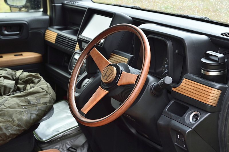 ステアリングもウッド製。スポーク部のカバーは本革で製作。ダッシュボードやドアトリムに圧縮木材を使っている。表面は未塗装で蜜蝋のみを塗っている