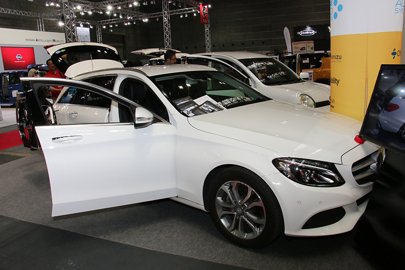 車いす収納ロボットアーム「TMN R11」を装着した「Cクラス ステーションワゴン」を展示。4.7m以上の全長を持つこのモデルの運転席横からラゲッジスペースに車いすを収納する長いアームを、ボディとのクリアランスを一定に保ちつつ、大きく横側に張り出さず動かせることがポイントとなっている