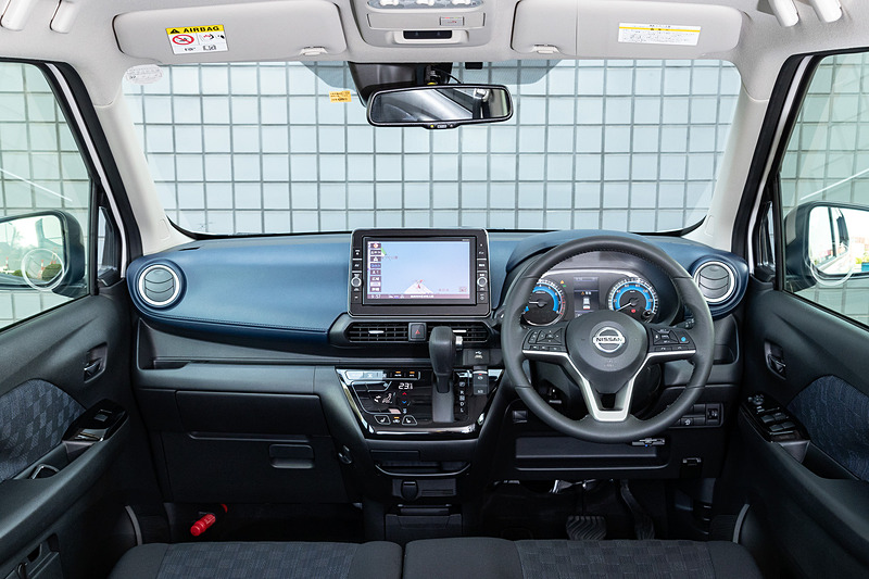 ハイウェイスターX プロパイロットエディションのインテリア。新型デイズでは新プラットフォームを採用し、従来からエンジンルームスペースを65mm縮小。その65mmをホイールベースに充てて2495mmを確保しており、「広いキャビンスペース」「広いラゲッジスペース」を両立させるパッケージを実現した。インテリアカラーはブラックを基調にブルーをインサートした「エボニー」（シート地：トリコット）