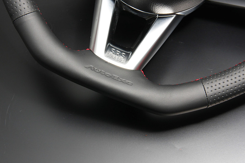 トップ部にリアルカーボンを採用するとともに、柔らかく耐久性のあるナッパレザー、ボトム部に配したAutoExe型押しロゴなどでスポーティさと高級感を両立