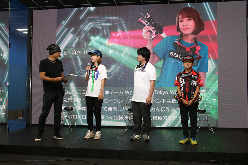 ドローンレーサーの白石麻衣選手、上関風雅選手、中尾侑資選手の3人によるドローンのデモレースを実施。司会とレース実況はピストン西沢氏が担当