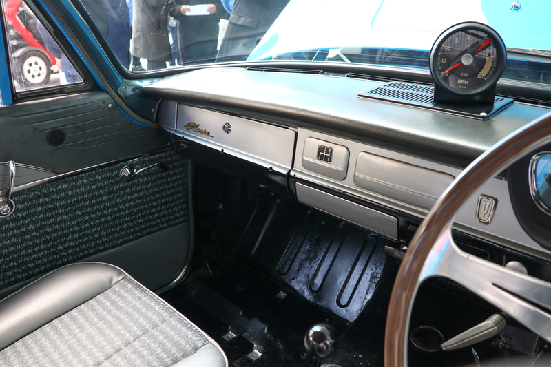 グローブボックスのロゴも角型のプレートだったが、当時のレース車の内装写真から筆記体のグロリアロゴに変更。アンテナの上下スイッチの穴を埋める蓋も当時に合わせてプリンスのロゴにしたほか、細かいところでは横に伸びるモールを外した仕様だったため、それも再現して穴が見えている