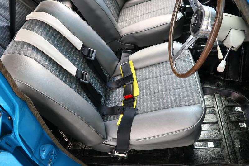 シートは当時と同じ西陣織で再生。シートベルトはレース用に装備
