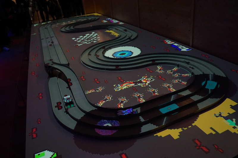 高速で走行するミニ四駆のボディカラーはプロジェクションマッピングを施して再現している