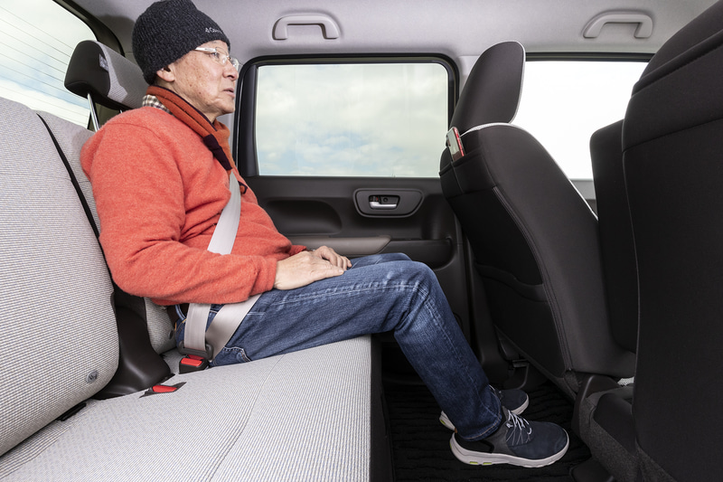 N-WGN L・Honda SENSINGのシート。華やかでありつつも落ち着いたアイボリーと、チョコレートのようなブラウンで室内を明るく演出する。リアシートを後端まで移動させると、成人男性が座っても余裕のある広々とした足下スペースが生まれる