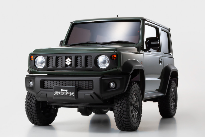 ジムニーシエラを象徴する5スロットグリル＆丸型ヘッドライトをメッキ加工し、独立ターンランプなど別体パーツで実感豊かに表現。エンブレムにもメッキ加工を施した