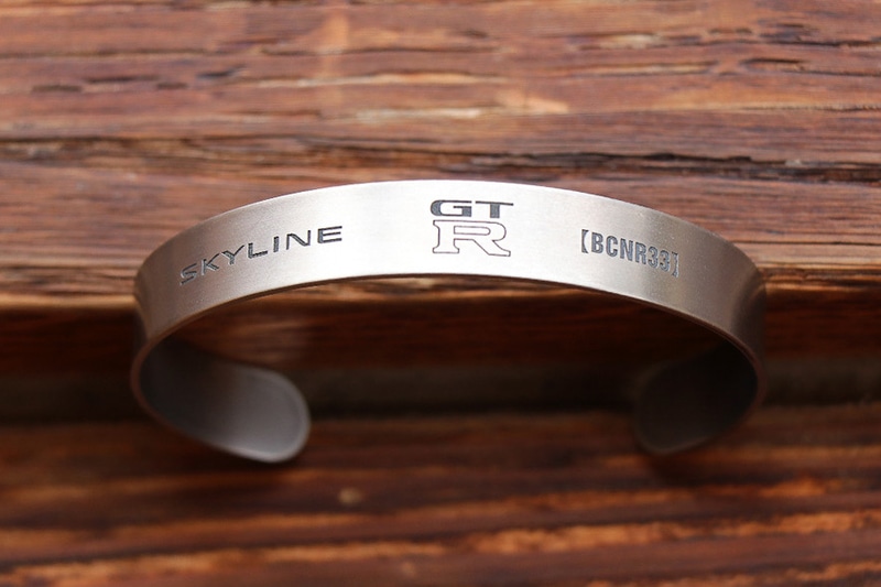 ボディはチタン特有の灰色がかったシルバーで、表面に各GT-Rのエンブレムや型番などを刻印