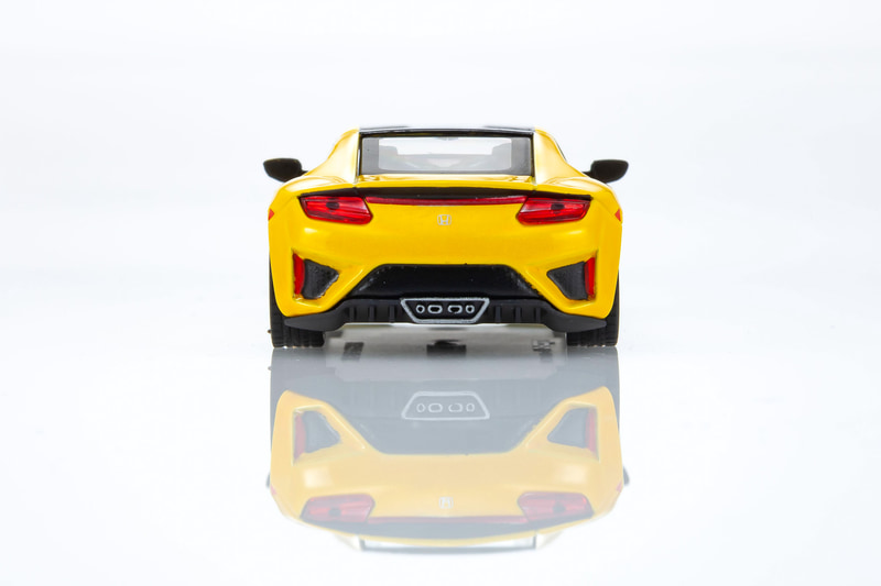 NSXの1/64スケールミニカーは、インディイエローパールIIをベースにしたカラーを採用。ディスプレイ用の台座も付属する