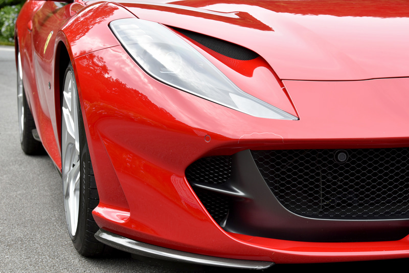 外観ではハイ・テールの2ボックススタイルが1969年の「365GTB4」を想起させ、フルLEDヘッドライトは隆起するフロントホイールアーチを含めてボンネットのエアインテークと一体でデザインすることでフロントの力強さを強調。リアまわりでは、フェラーリ伝統の4灯丸型テールランプが水平方向に広がるフォルムを強調し、スポイラーとキャビンを低く見せる視覚的効果によってワイド＆ローを演出しているという。エキゾーストパイプはチタニウム製