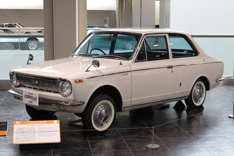 1966年発売、トヨタ・カローラ（KE10型）。1077cc、水冷4気筒OHVエンジン搭載。この時代は2ドアセダンが大衆車の標準仕様だった。累計出荷台数は1997年にフォルクスワーゲン・ビートルを抜き世界1位（トヨタ博物館展示車）