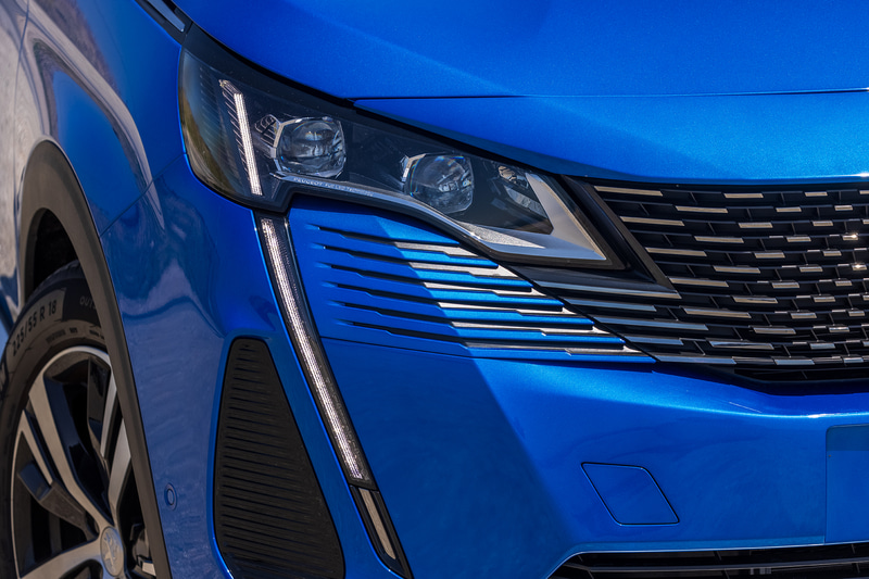 フロントまわりのデザインを一新し、特徴的なフレームレスグリルを採用。LEDデイタイムライトは新世代プジョーのデザインコードでもある牙状となり、ヘッドライトから連続するデザイン。ウインカーを点灯すると、LEDデイタイムライト部分が光る