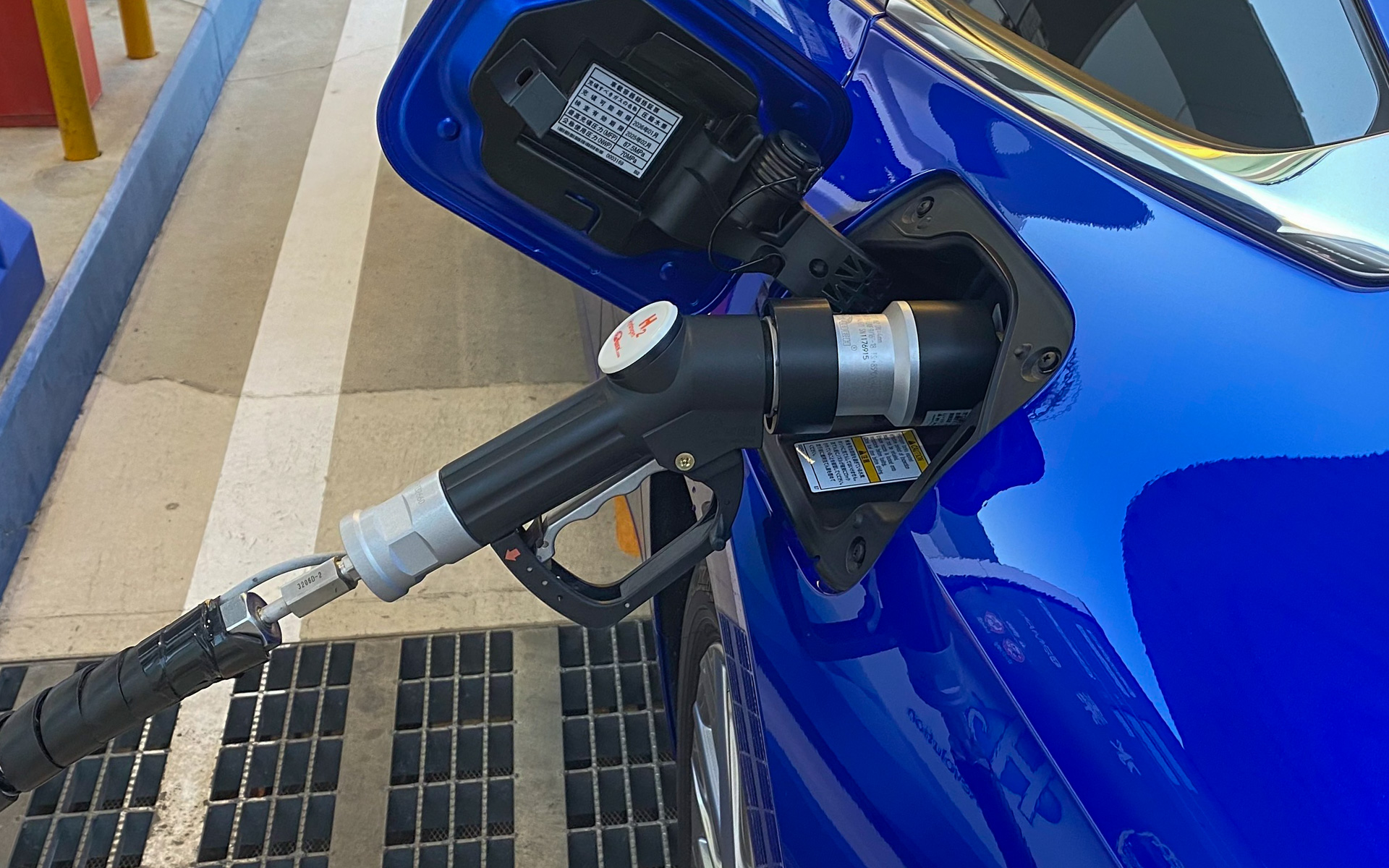 水素の充填口が左リアにあり、こんな風にガソリンスタンドと変わらない感じで充填がスタート。リッドの裏には車両の水素タンクが使用できる期限が記されていて、これを過ぎている車両には充填できないんだとか。この期限は定期的な検査を受けて延長できるそうで、こうした安全対策もアップデートされてるんですね