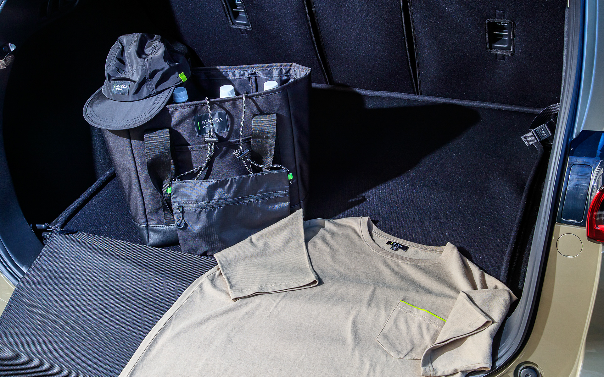 こちらは2022年2月にマツダ販売店、マツダコレクション（オンラインショップ）で販売を開始するフィールドジャーニーをフィーチャーしたグッズ類。フィールドジャーニーに採用された内外装のテーマカラーを随所に採用したのが特徴で、ジルコンサンドカラーを用いたビックシルエットのTシャツやライムグリーンのアクセントを配したステンレスボトル、オールチタン製の1層構造のカップなどアウトドアでもタウンユースでも使えるアイテムが揃えられている