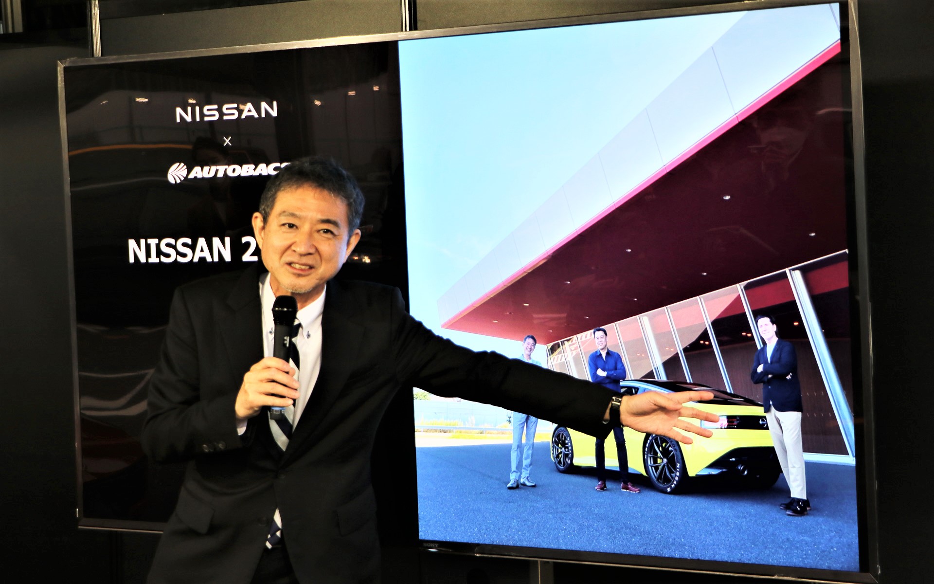 内田社長とデザイン担当アルフォンソ氏と田村氏の3人が写った写真を前に当時を振り返る