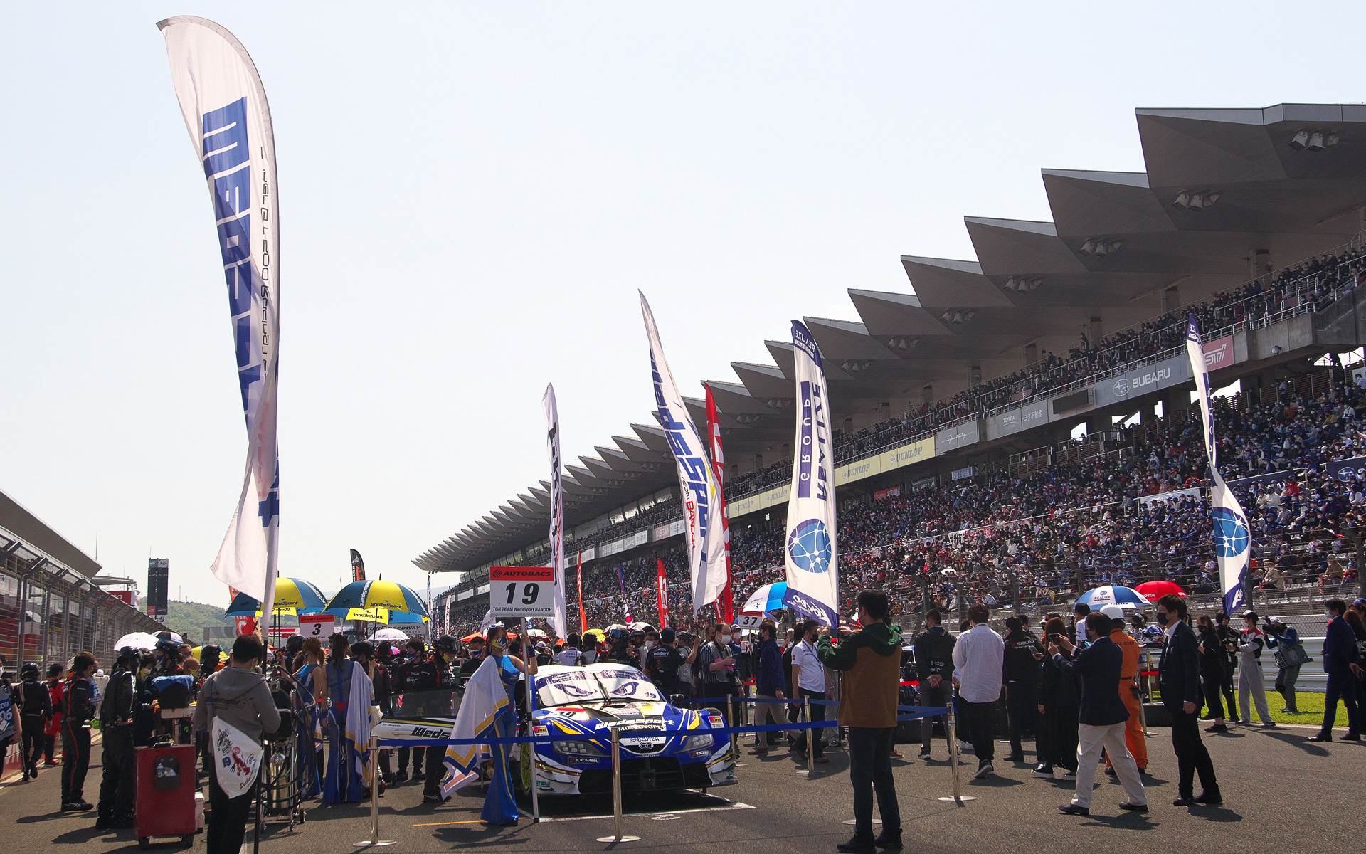 多くの観客が詰めかけた富士スピードウェイのスタンドとグリッド