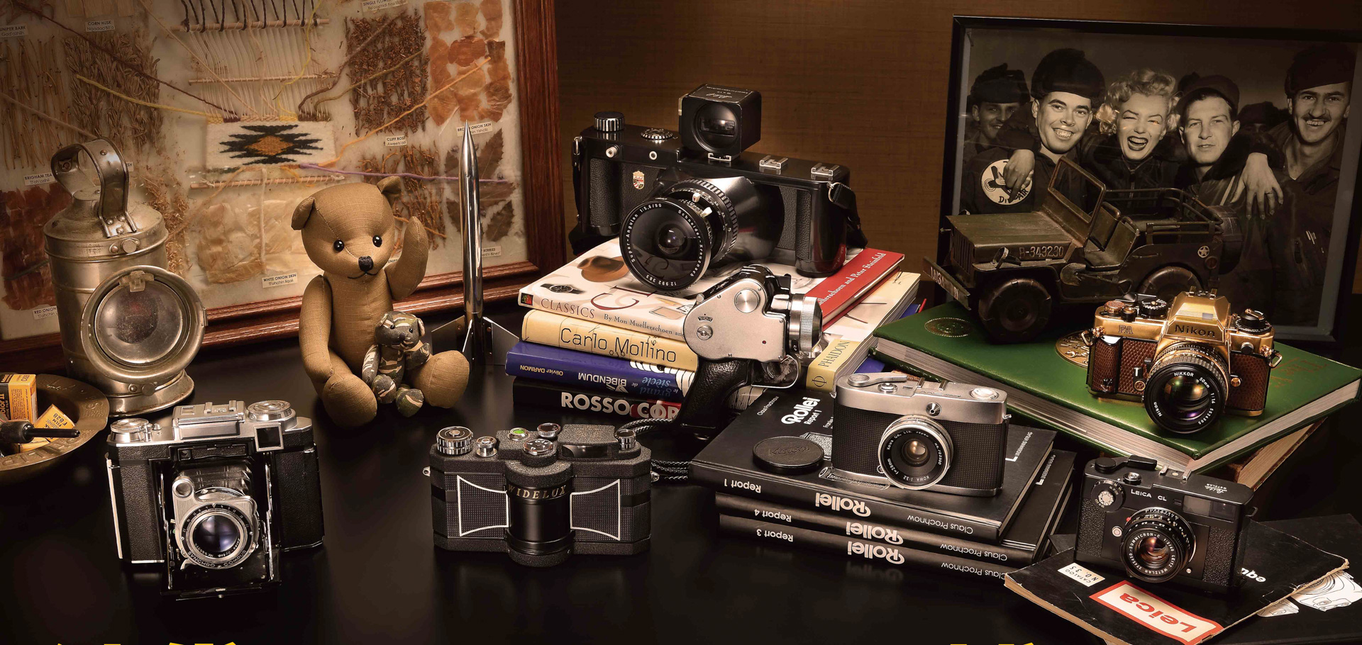 写真は左から、（1）Universal Super 6V：49,500円、（2）Widelux F8：120,000円、（3）Linhof617：280,000円、（4）Mamiya Pistol：948,000円、（5）Kowa　SW：48,000円、（6）Nikon FA Gold：198,000円、（7）Leica CL Summicron 40mm F2：165,000円