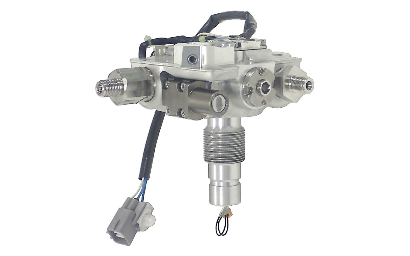 「高圧水素バルブ」。水素燃料電池自動車（FCEV）の燃料となる高圧水素が貯蔵されているタンクに装着され、高圧水素を封止および、供給する。水素供給流量を従来比40％向上させるとともに、バルブ全長削減により水素タンク容積が25％拡大し、FCEVの航続距離向上に貢献する。