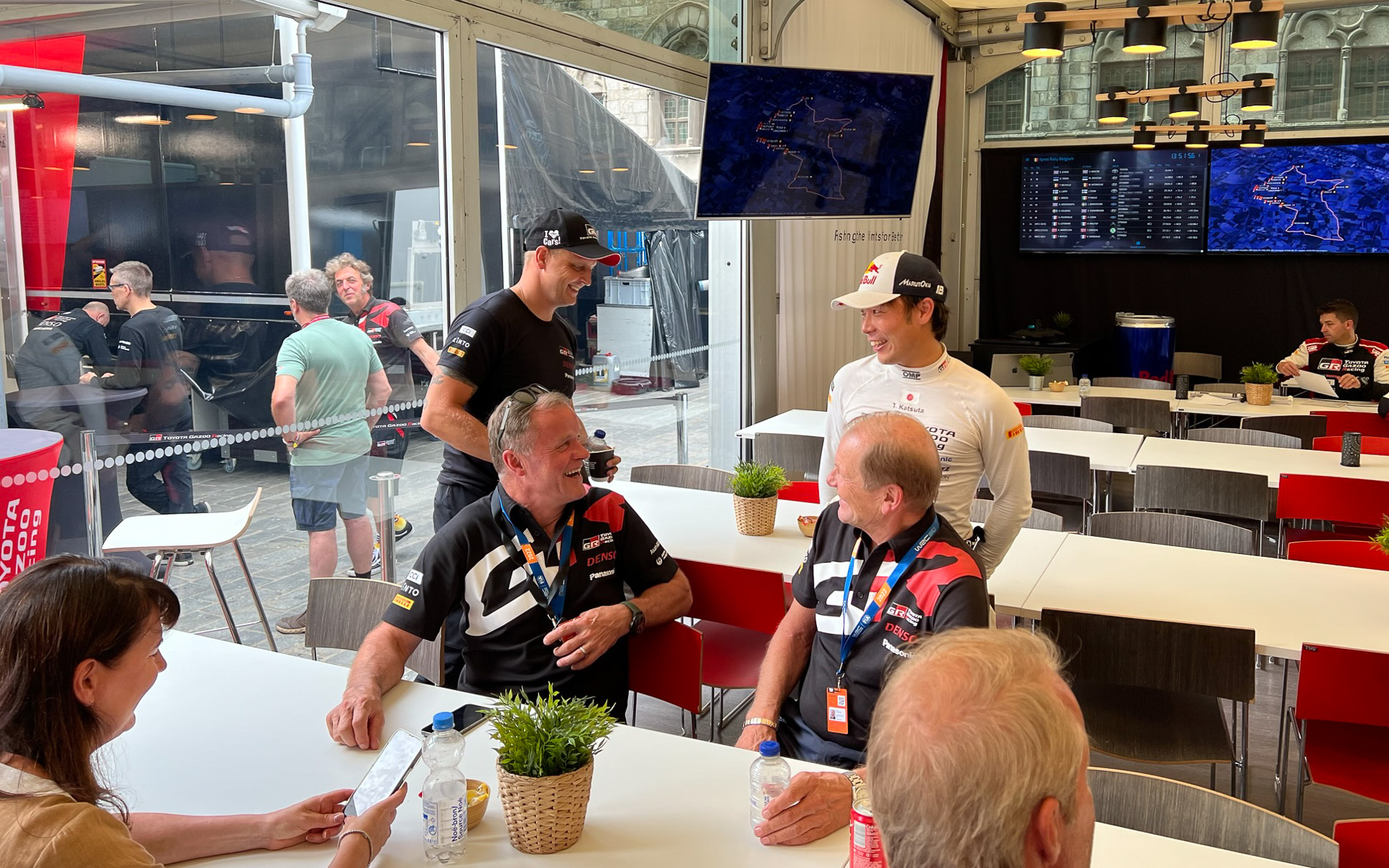 ラリー・ベルギーにおいてWRCドライバーの勝田貴元選手と談笑するトミ・マキネン氏（中央左）とユハ・カンクネン氏（中央右）