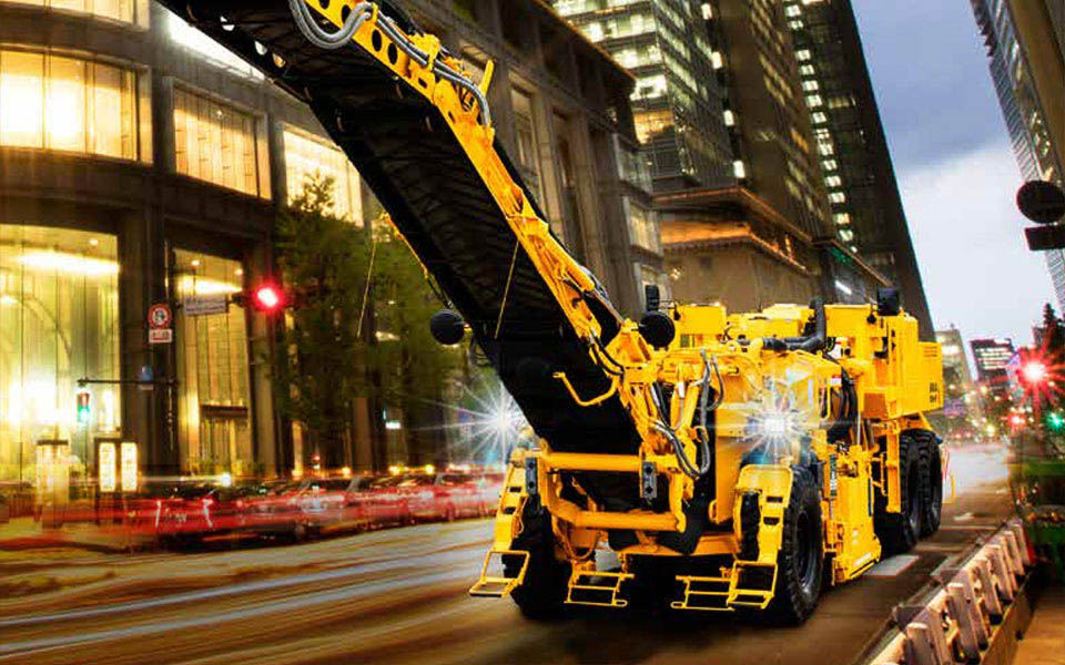 道路のひび割れや凸凹の補修工事のほか、鉱物の採掘、岩盤切削などで使用する、車両全長10m超えの大型建機「路面切削機 ER555F」（上）、「路面切削機 W210Fi」（下）が初登場