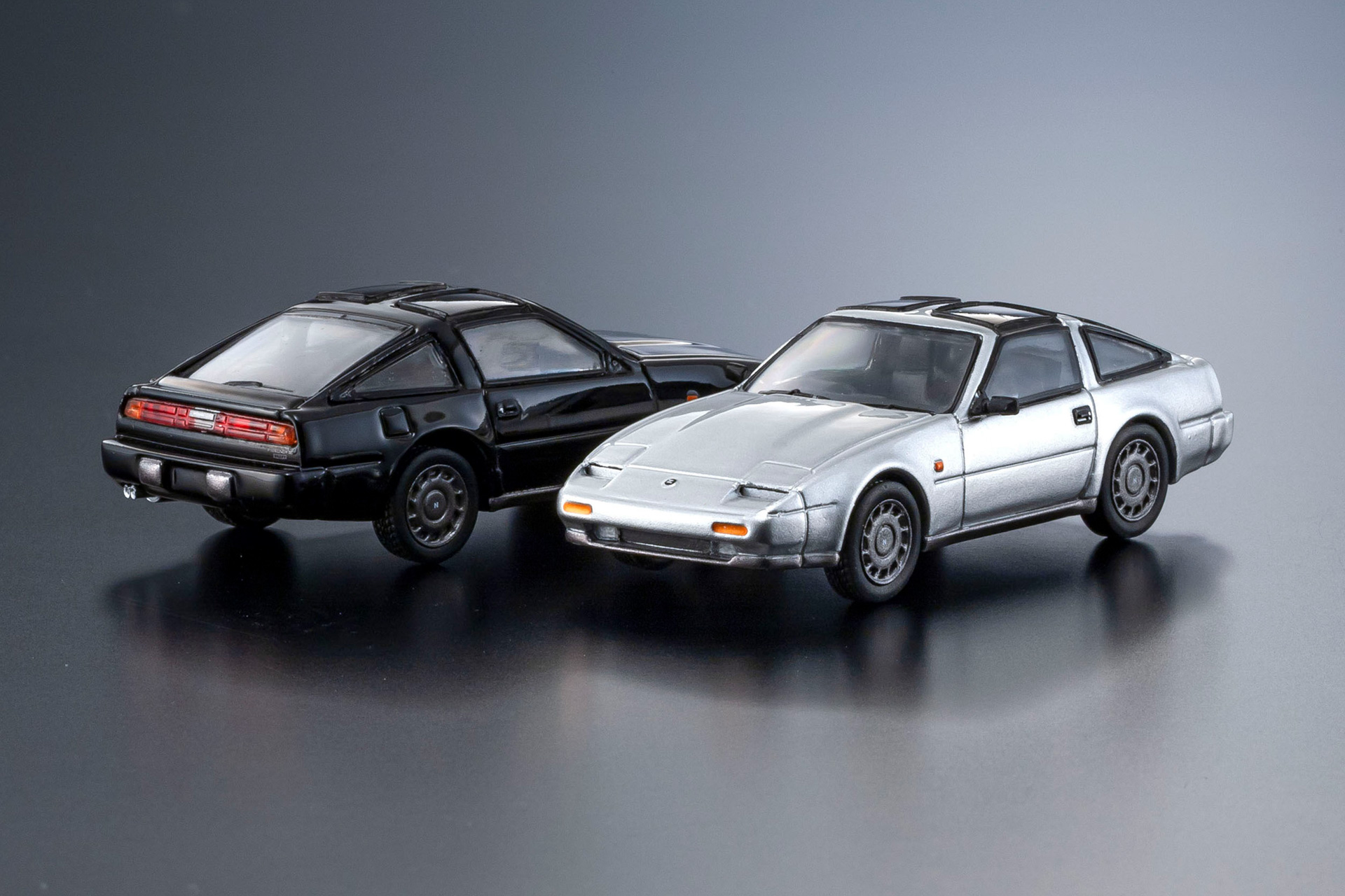 No.10 ,11 NISSAN FAIRLADY Z：フェアレディZ伝統のロングノーズ&ショートデッキを受け継ぎながら、卓越した空力性能と国産車最強のV6エンジンを得て、欧州スポーツカーと真っ向勝負を挑んだエポックメイキングなクルマ。その圧倒的なパワーに多くの人が憧れた。1986年のマイナーチェンジでは直線基調からグラマラスなデザインへと刷新されている