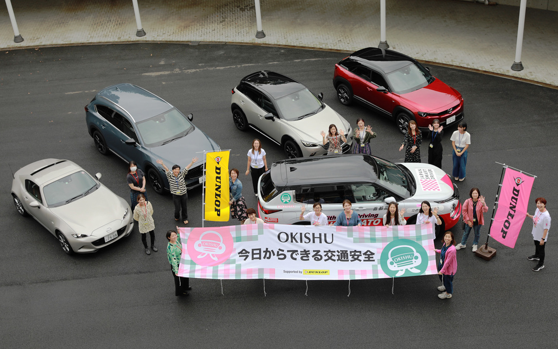 OKISHUプロジェクト「今日からできる交通安全〜お肌も運転も美しく〜　supported by DUNLOP」のイベントが、9月23日にマツダR&Dセンター横浜にて開催されました。MX-30やCX-8といったマツダの人気モデルたちで運転ポジションの取り方、車庫入れのコツをレクチャー。ホメパトとOKISHUのコラボ車両である三菱アウトランダーPHEVで、タイヤチェックをレクチャーしました。ピンクのDUNLOPは10月の「ピンクリボン月間」だけ現れるレアなロゴです