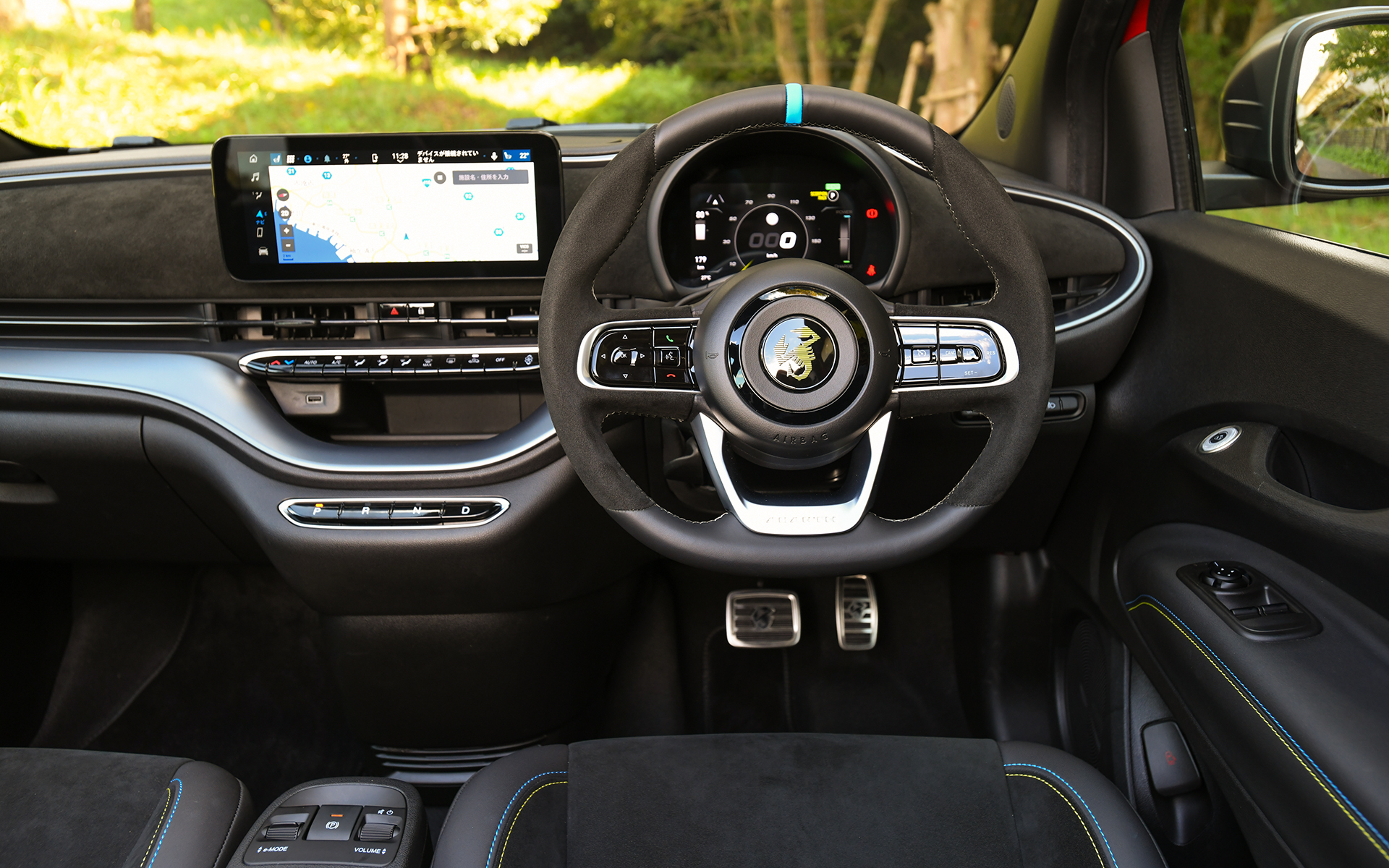 黒を基調としたシックでスポーティなインテリア。インストルメントパネル、ステアリング、ヘッドレスト一体型スポーツシートなどにアルカンターラ素材を採用し、高級感を演出。ヘッドレストには「Abarth 500e」専用のロゴをあしらい、ブルーとイエローのステッチを施した一体型のスポーツシート、ステアリングホイールにあしらったブルーのトップマークとともにスポーティさを高めている