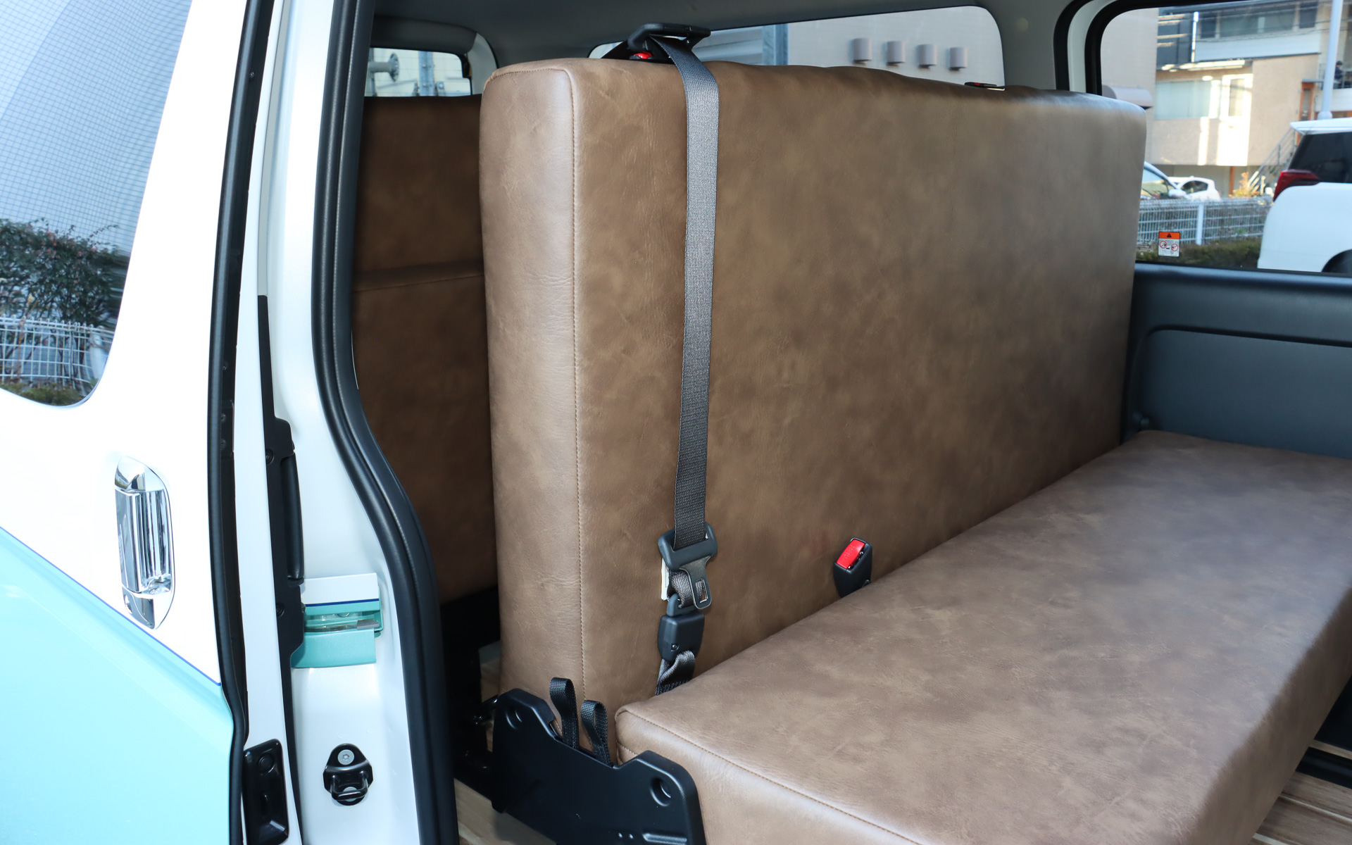 REVOシートは巻き取り格納式のシートベルトをベース部分に設置。走行時にはシートバックなどのバックルを使い、3連式シートベルトとして利用する