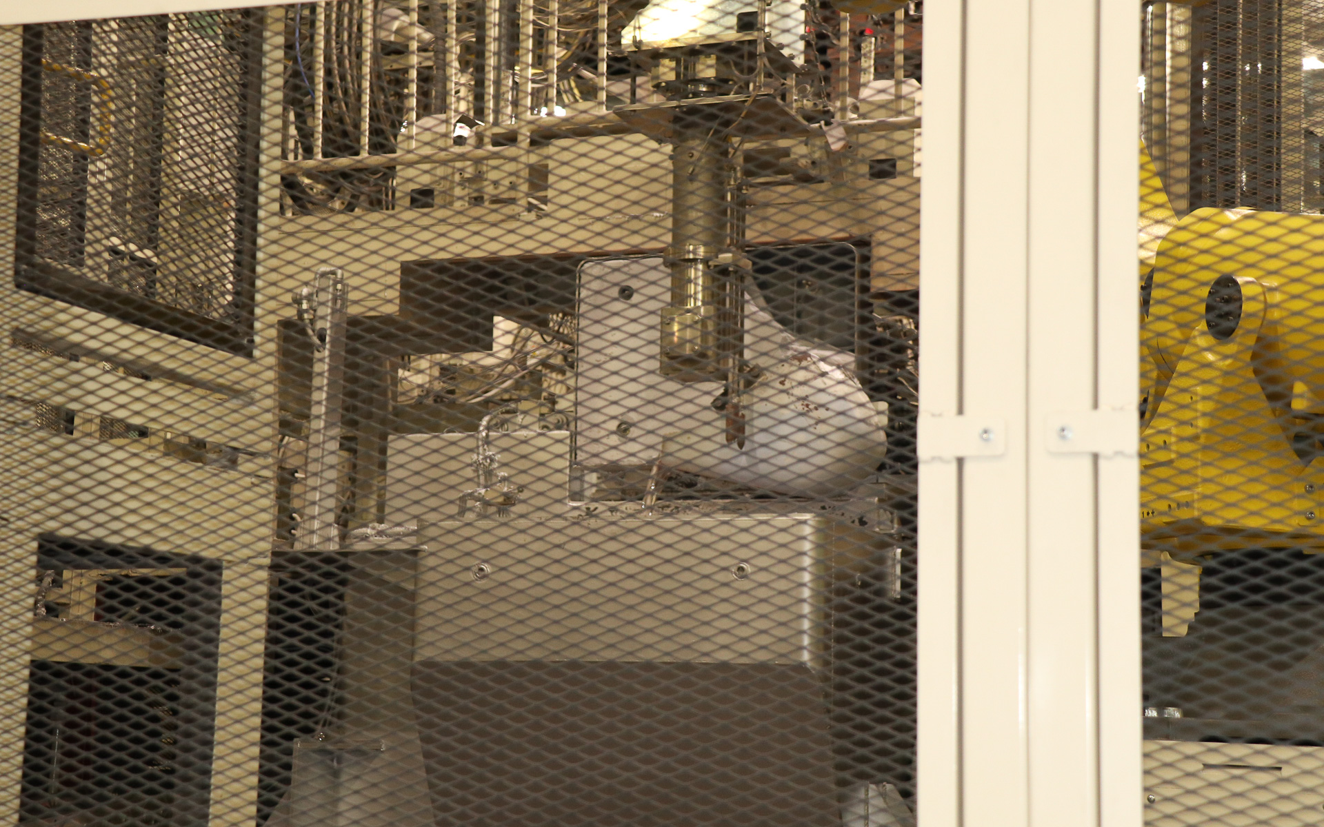 ロボットアームが溶けたアルミを鋳型に流し込んでいく