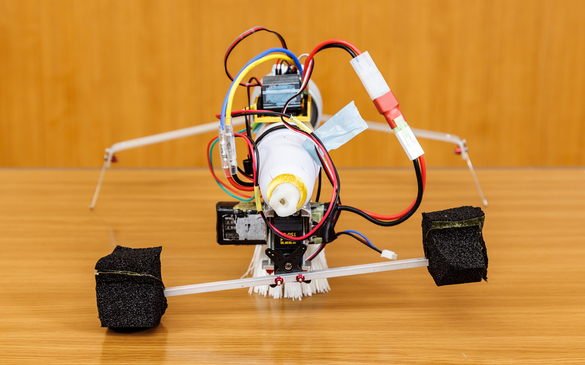 1.5号機をさまざまな角度から。電動マッサージ器の振動をブラシに伝え、ブラシのたわみを推進力にして前進。後方についているストックを動かして方向を変えるのだが、撮影時はストックが左にかたむいてしまっていた。制作費の総額は2万5532円