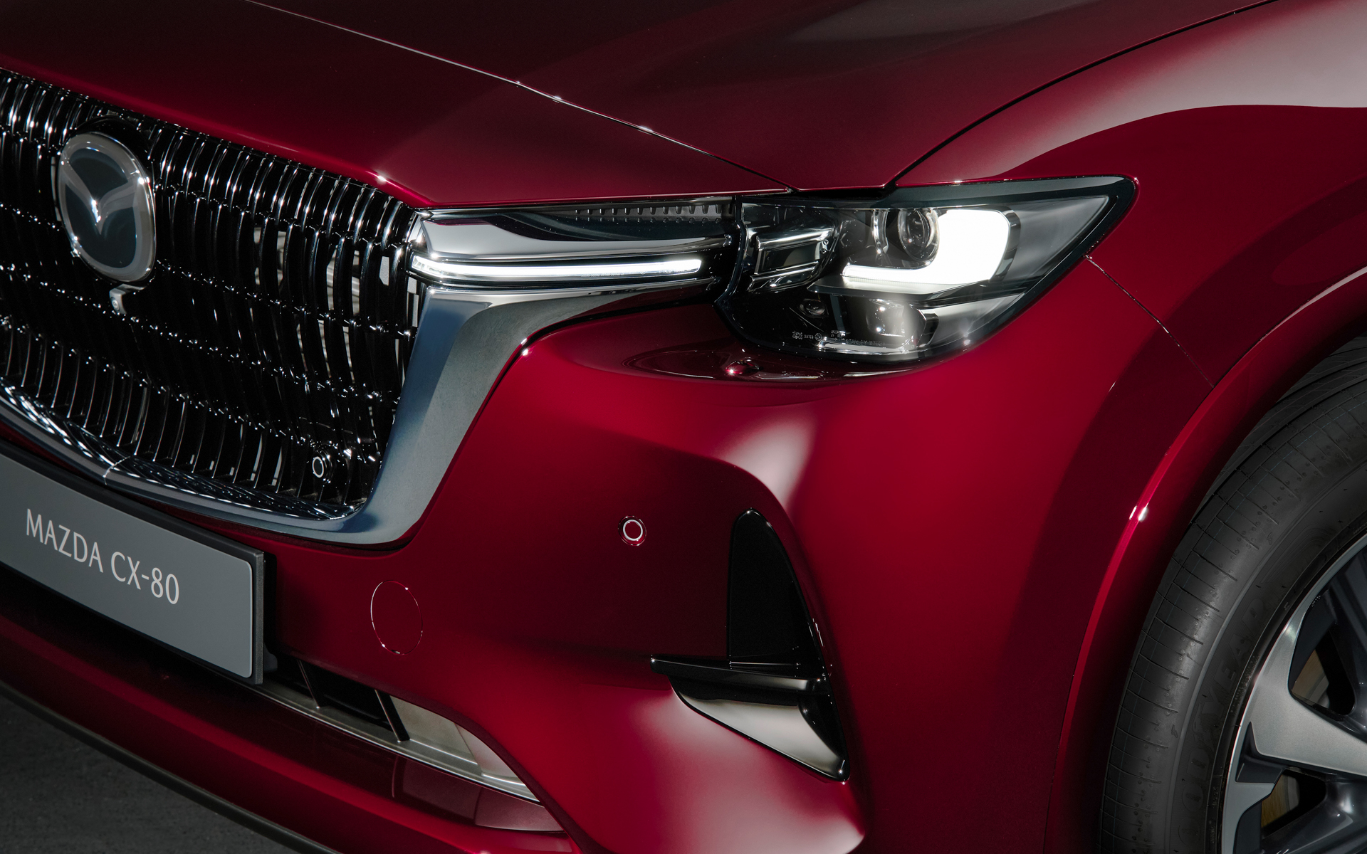 グリルメッシュはCX-60と同じデザインの縦フィンに統一し、左側にCX-80を表す専用のアクセントが配される