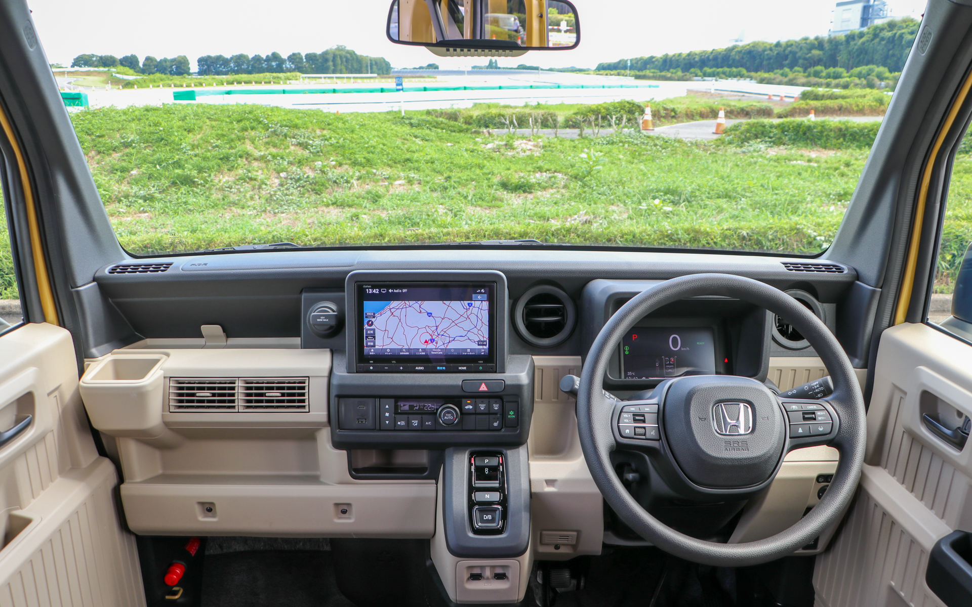 e：FUNのインテリアはベージュカラー。視界の広い水平基調はそのままだが、シフトがレバー式からボタン式に、ステアリングも3本から2本スポークに改められた