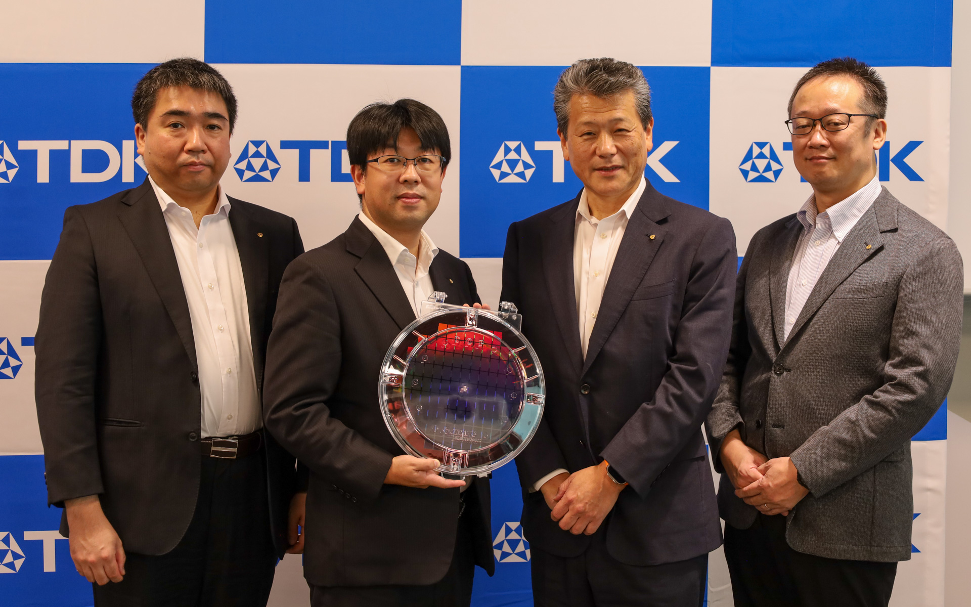 左から、TDK株式会社の技術・知財本部応用製品開発センター次世代電子部品開発部第 2 開発室 担当課長 柴田竜雄氏、技術・知財本部応用製品開発センター次世代電子部品開発部第 2 開発室長 佐々木智生氏、取締役 常務執行役員 CTO 佐藤茂樹氏、技術・知財本部　応用製品開発センター ゼネラルマネージャー 榎戸靖氏