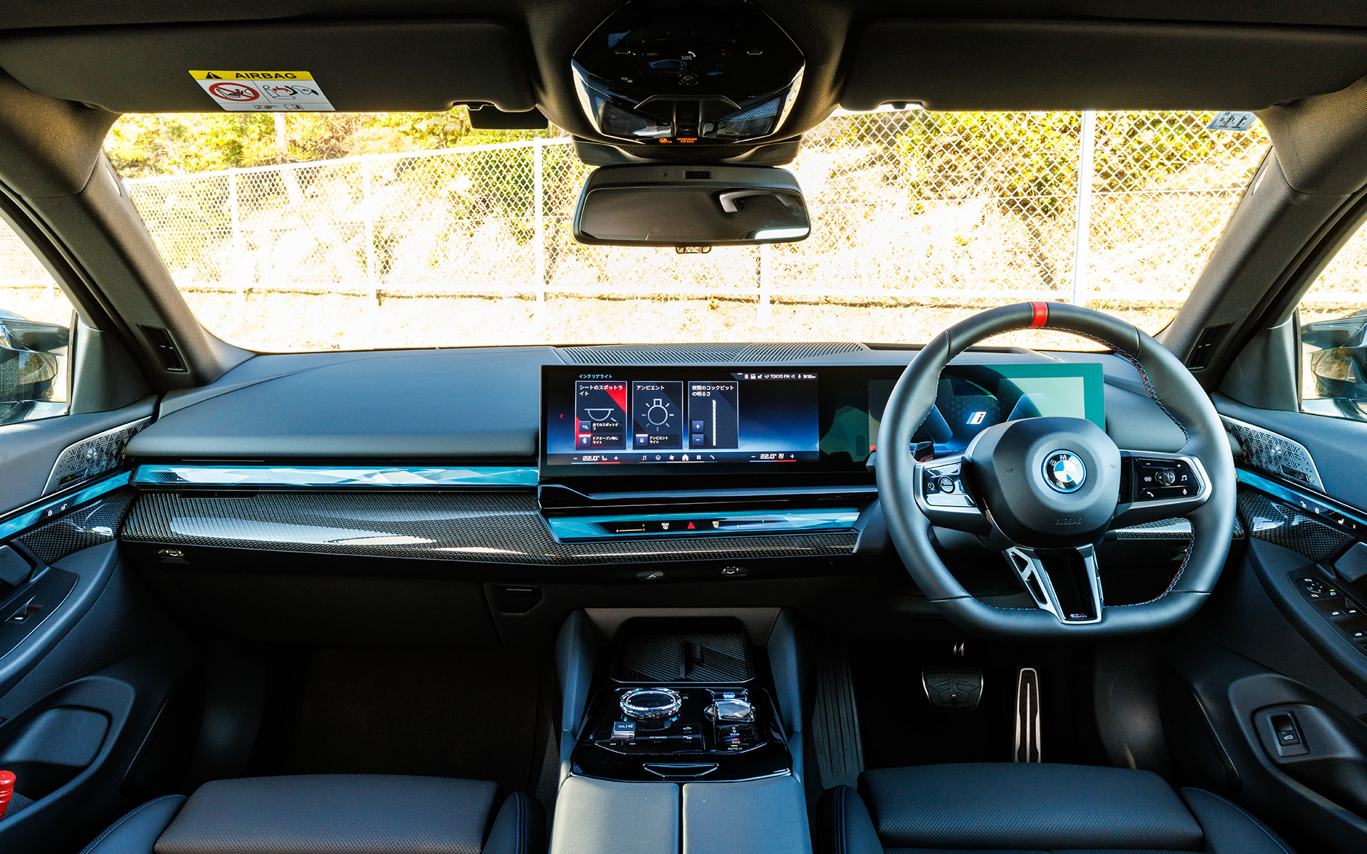 i5 M60 xDriveのコクピット。インテリアとリムはカーボン・ファイバー・ハイグロス・シルバー・スレッド・トリム（ダーク・シルバー M アクセント）を標準装備