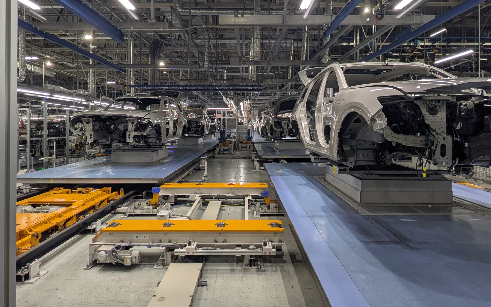 ボディを乗せた台車が左右2本のラインを流れる。右側は手前に流れ、「トラバーサー」と呼ばる部分で横移動し、今度は左側のラインで奥へと流れていく。レールや台車の数変更とトラバーサーを移設することで、短期間でラインの延長と短縮が可能となる